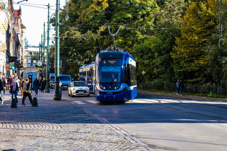 Krakow, Poland - October 08, 2022 Modern electric tram driving in the streets of Krakow and part of the transport system of the city, the fares are not expensiveのeditorial素材