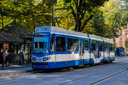 Krakow, Poland - October 08, 2022 Modern electric tram driving in the streets of Krakow and part of the transport system of the city, the fares are not expensiveのeditorial素材