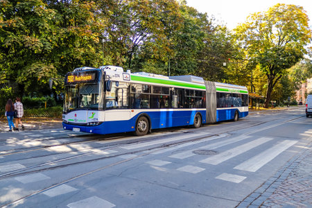 Krakow, Poland - October 08, 2022 Bus driving in the streets of Krakow and part of the transport system of the city, the fares are not expensiveのeditorial素材