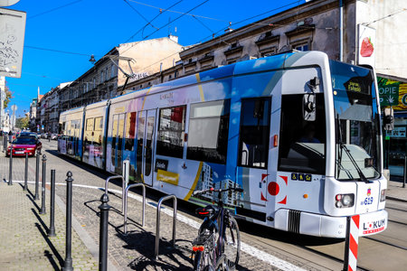 Krakow, Poland - October 08, 2022 Modern electric tram driving in the streets of Krakow and part of the transport system of the city, the fares are not expensiveのeditorial素材
