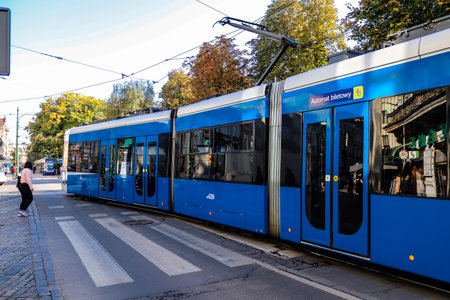 Krakow, Poland - October 08, 2022 Modern electric tram driving in the streets of Krakow and part of the transport system of the city, the fares are not expensiveのeditorial素材