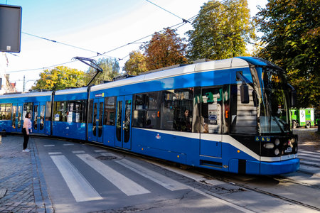 Krakow, Poland - October 08, 2022 Modern electric tram driving in the streets of Krakow and part of the transport system of the city, the fares are not expensiveのeditorial素材
