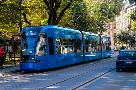 Krakow, Poland - October 08, 2022 Modern electric tram driving in the streets of Krakow and part of the transport system of the city, the fares are not expensiveのeditorial素材