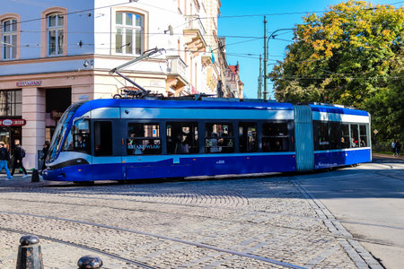 Krakow, Poland - October 08, 2022 Modern electric tram driving in the streets of Krakow and part of the transport system of the city, the fares are not expensiveのeditorial素材