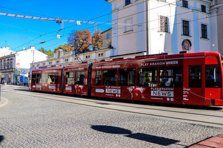 Krakow, Poland - October 08, 2022 Modern electric tram driving in the streets of Krakow and part of the transport system of the city, the fares are not expensiveのeditorial素材