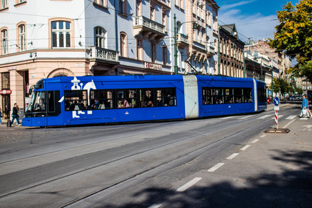 Krakow, Poland - October 08, 2022 Modern electric tram driving in the streets of Krakow and part of the transport system of the city, the fares are not expensiveのeditorial素材