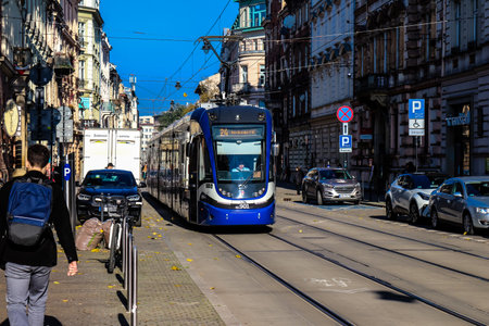 Krakow, Poland - October 08, 2022 Modern electric tram driving in the streets of Krakow and part of the transport system of the city, the fares are not expensiveのeditorial素材