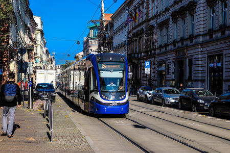 Krakow, Poland - October 08, 2022 Modern electric tram driving in the streets of Krakow and part of the transport system of the city, the fares are not expensiveのeditorial素材