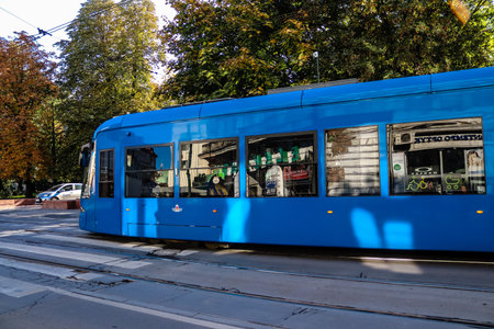 Krakow, Poland - October 08, 2022 Modern electric tram driving in the streets of Krakow and part of the transport system of the city, the fares are not expensiveのeditorial素材