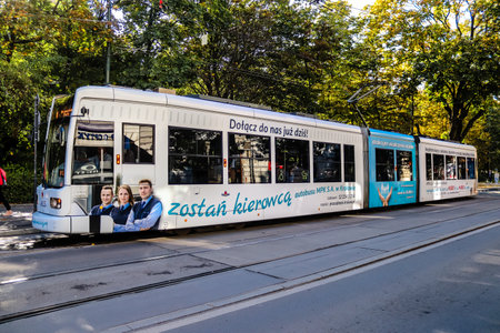 Krakow, Poland - October 08, 2022 Modern electric tram driving in the streets of Krakow and part of the transport system of the city, the fares are not expensiveのeditorial素材