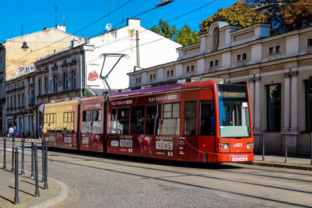 Krakow, Poland - October 08, 2022 Modern electric tram driving in the streets of Krakow and part of the transport system of the city, the fares are not expensiveのeditorial素材