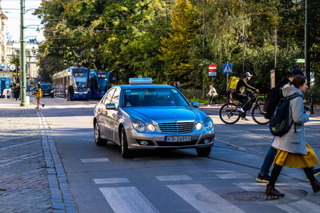 Krakow, Poland - October 08, 2022 Taxi driving in the streets of Krakow and part of the transport system of the city, several taxi companies compete for this activity and the fares are not expensiveのeditorial素材