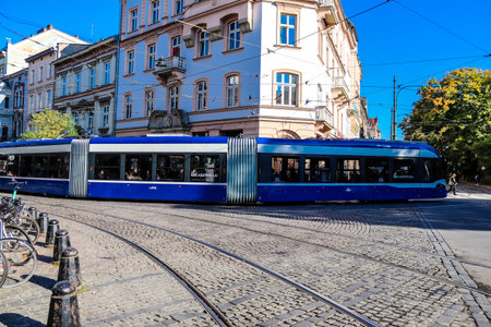 Krakow, Poland - October 08, 2022 Modern electric tram driving in the streets of Krakow and part of the transport system of the city, the fares are not expensiveのeditorial素材