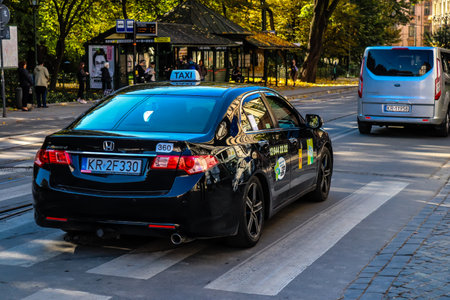 Krakow, Poland - October 08, 2022 Taxi driving in the streets of Krakow and part of the transport system of the city, several taxi companies compete for this activity and the fares are not expensiveのeditorial素材