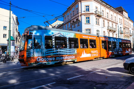 Krakow, Poland - October 08, 2022 Modern electric tram driving in the streets of Krakow and part of the transport system of the city, the fares are not expensiveのeditorial素材