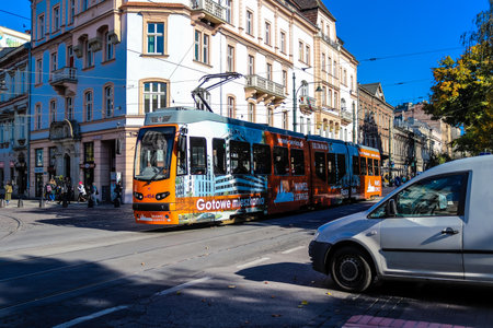Krakow, Poland - October 08, 2022 Modern electric tram driving in the streets of Krakow and part of the transport system of the city, the fares are not expensiveのeditorial素材