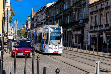 Krakow, Poland - October 08, 2022 Modern electric tram driving in the streets of Krakow and part of the transport system of the city, the fares are not expensiveのeditorial素材