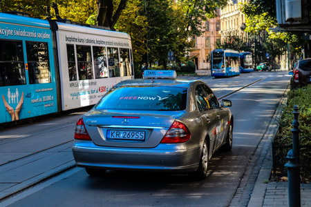 Krakow, Poland - October 08, 2022 Taxi driving in the streets of Krakow and part of the transport system of the city, several taxi companies compete for this activity and the fares are not expensiveのeditorial素材