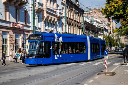 Krakow, Poland - October 08, 2022 Modern electric tram driving in the streets of Krakow and part of the transport system of the city, the fares are not expensiveのeditorial素材