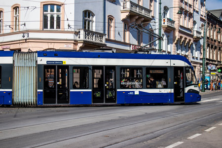 Krakow, Poland - October 08, 2022 Modern electric tram driving in the streets of Krakow and part of the transport system of the city, the fares are not expensiveのeditorial素材