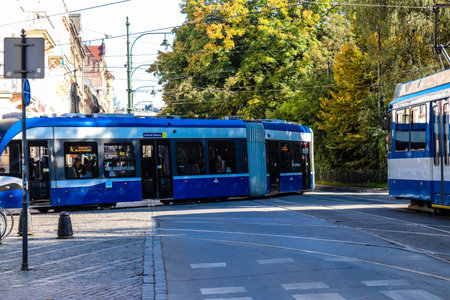 Krakow, Poland - October 08, 2022 Modern electric tram driving in the streets of Krakow and part of the transport system of the city, the fares are not expensiveのeditorial素材