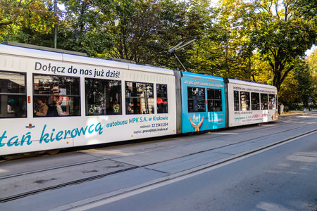 Krakow, Poland - October 08, 2022 Modern electric tram driving in the streets of Krakow and part of the transport system of the city, the fares are not expensiveのeditorial素材