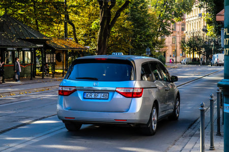 Krakow, Poland - October 08, 2022 Taxi driving in the streets of Krakow and part of the transport system of the city, several taxi companies compete for this activity and the fares are not expensiveのeditorial素材
