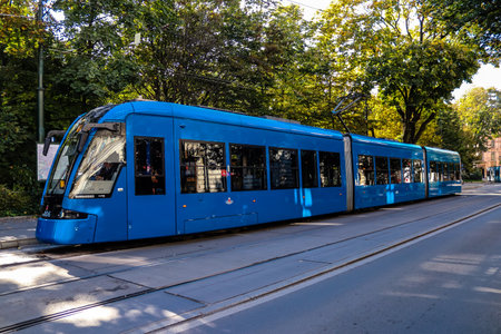 Krakow, Poland - October 08, 2022 Modern electric tram driving in the streets of Krakow and part of the transport system of the city, the fares are not expensiveのeditorial素材