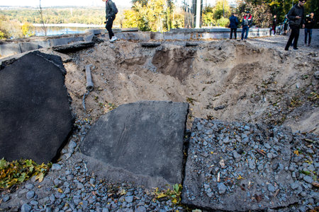 Aftermath of massive Russian missile attacks, a public garden near the Friendship Arch of Kyiv in the city center was hit hard. Missiles hit in 4 places in the city of Kyiv. 9 people died and 36 people were injured. Russia threatens more strikes after misのeditorial素材