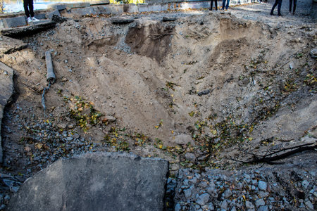 Aftermath of massive Russian missile attacks, a public garden near the Friendship Arch of Kyiv in the city center was hit hard. Missiles hit in 4 places in the city of Kyiv. 9 people died and 36 people were injured. Russia threatens more strikes after misのeditorial素材