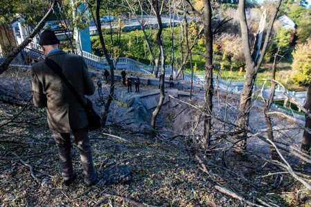 Aftermath of massive Russian missile attacks, a public garden near the Friendship Arch of Kyiv in the city center was hit hard. Missiles hit in 4 places in the city of Kyiv. 9 people died and 36 people were injured. Russia threatens more strikes after misのeditorial素材