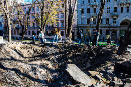 Aftermath of massive Russian missile attacks, a public garden in the city center was hit hard. Missiles hit in 4 places in the city of Kyiv. 9 people died and 36 people were injured. Russia threatens more strikes after missiles hit cities across Ukraineのeditorial素材