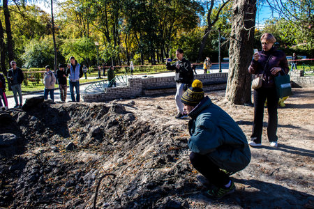 Aftermath of massive Russian missile attacks, a public garden in the city center was hit hard. Missiles hit in 4 places in the city of Kyiv. 9 people died and 36 people were injured. Russia threatens more strikes after missiles hit cities across Ukraineのeditorial素材