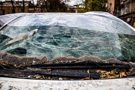 Aftermath of massive Russian missile attacks, cars around the Samsung office building was hit hard. The damage to the vehicles is considerable and several of them are destroyed.のeditorial素材