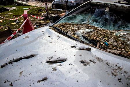 Aftermath of massive Russian missile attacks, cars around the Samsung office building was hit hard. The damage to the vehicles is considerable and several of them are destroyed.のeditorial素材