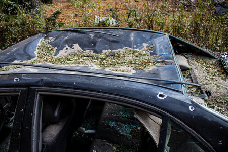Aftermath of massive Russian missile attacks, cars around the Samsung office building was hit hard. The damage to the vehicles is considerable and several of them are destroyed.のeditorial素材