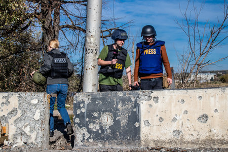 Group of television journalists and war photographers working in the city of Bakhmut, covering the war under the bombardments of the russian army, they are in the conflict zone and provide direct information on the situationのeditorial素材
