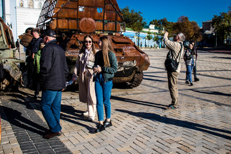 People visiting an open air exhibition and features Russian military equipment that was captured and destroyed during the 2022 Russian invasion of Ukraineのeditorial素材