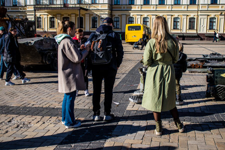 People visiting an open air exhibition and features Russian military equipment that was captured and destroyed during the 2022 Russian invasion of Ukraineのeditorial素材
