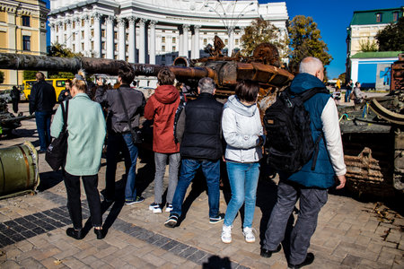 People visiting an open air exhibition and features Russian military equipment that was captured and destroyed during the 2022 Russian invasion of Ukraineのeditorial素材