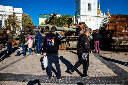 People visiting an open air exhibition and features Russian military equipment that was captured and destroyed during the 2022 Russian invasion of Ukraineのeditorial素材