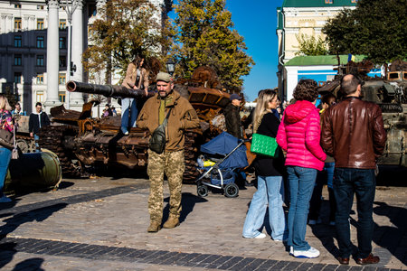People visiting an open air exhibition and features Russian military equipment that was captured and destroyed during the 2022 Russian invasion of Ukraineのeditorial素材