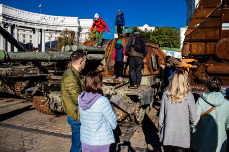 People visiting an open air exhibition and features Russian military equipment that was captured and destroyed during the 2022 Russian invasion of Ukraineのeditorial素材