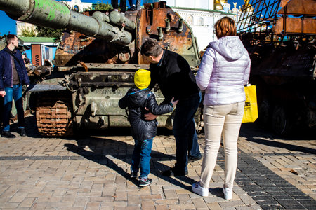 People visiting an open air exhibition and features Russian military equipment that was captured and destroyed during the 2022 Russian invasion of Ukraineのeditorial素材