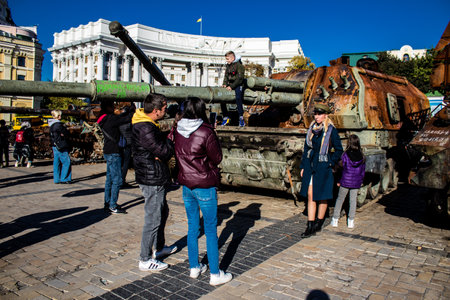 People visiting an open air exhibition and features Russian military equipment that was captured and destroyed during the 2022 Russian invasion of Ukraineのeditorial素材
