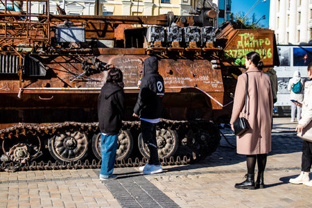 People visiting an open air exhibition and features Russian military equipment that was captured and destroyed during the 2022 Russian invasion of Ukraineのeditorial素材
