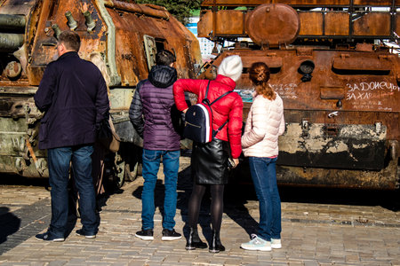 People visiting an open air exhibition and features Russian military equipment that was captured and destroyed during the 2022 Russian invasion of Ukraineのeditorial素材