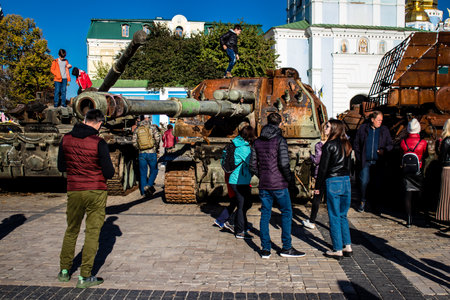 People visiting an open air exhibition and features Russian military equipment that was captured and destroyed during the 2022 Russian invasion of Ukraineのeditorial素材