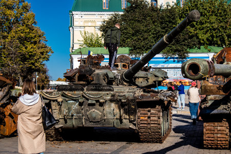 People visiting an open air exhibition and features Russian military equipment that was captured and destroyed during the 2022 Russian invasion of Ukraineのeditorial素材