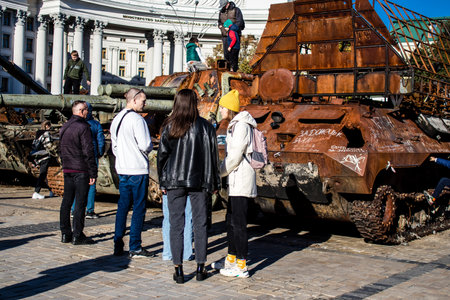 People visiting an open air exhibition and features Russian military equipment that was captured and destroyed during the 2022 Russian invasion of Ukraineのeditorial素材